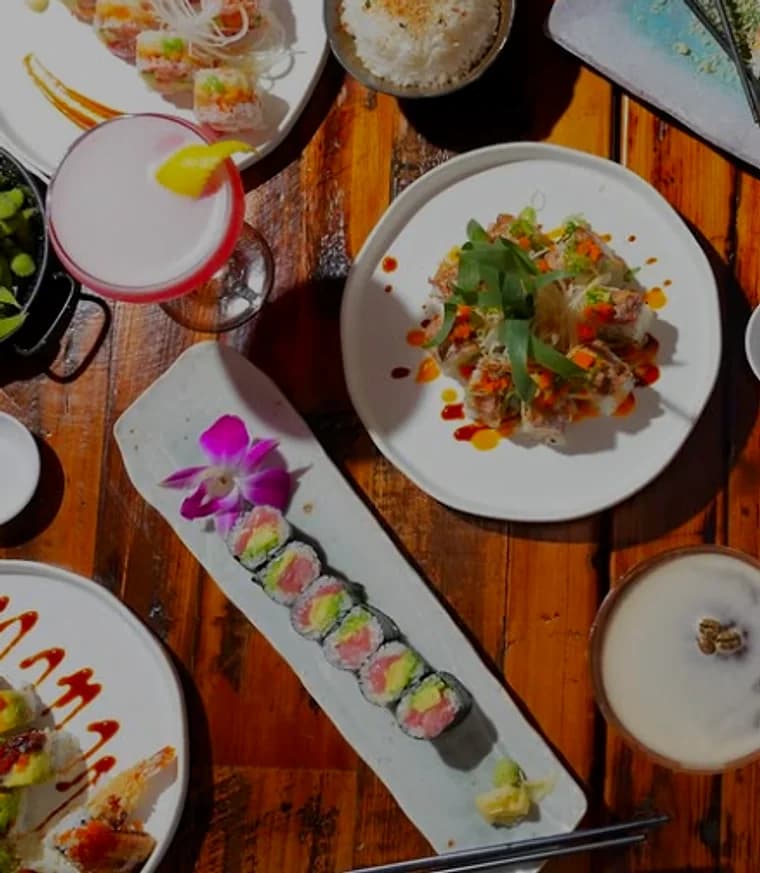 Rolls, rice and cocktails spread across a shared table